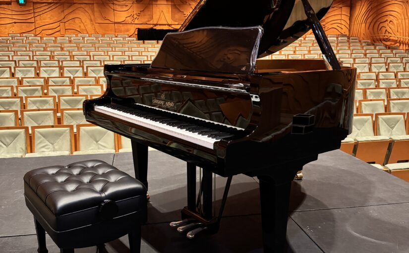 Professional piano movers transporting a grand piano using specialist equipment in Melbourne.